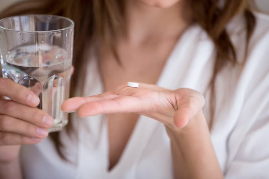 Melatonin Dosage: How Much Melatonin to Take Woman Taking Melatonin
